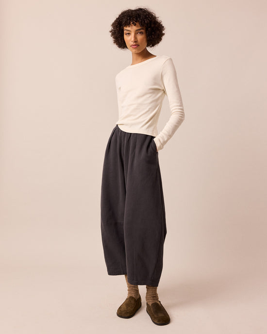 model wears daisy slate fleeceback jersey trousers left