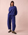 model wears daisy french blue fleeceback jersey trousers left