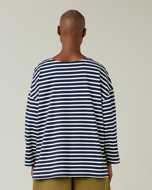 model wears navy and ecru breton top