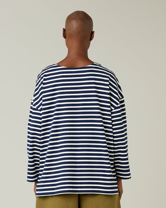 model wears navy and ecru breton top