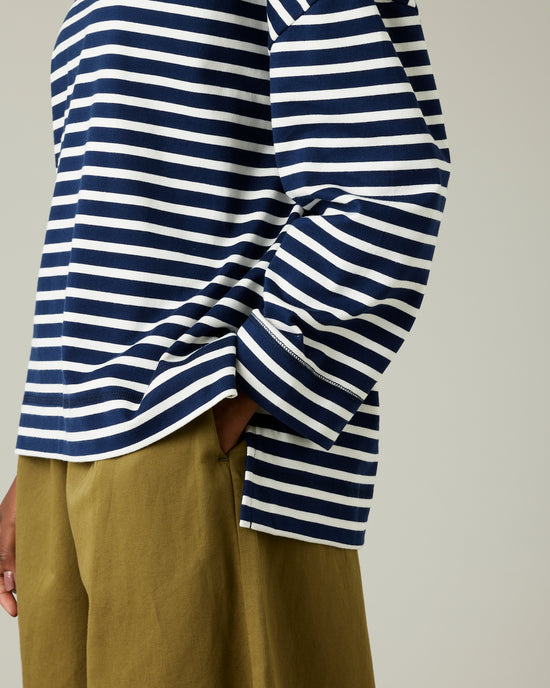 model wears navy and ecru breton top