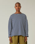 model wears navy and ecru breton top