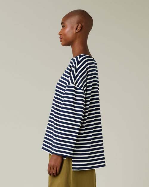 model wears navy and ecru breton top