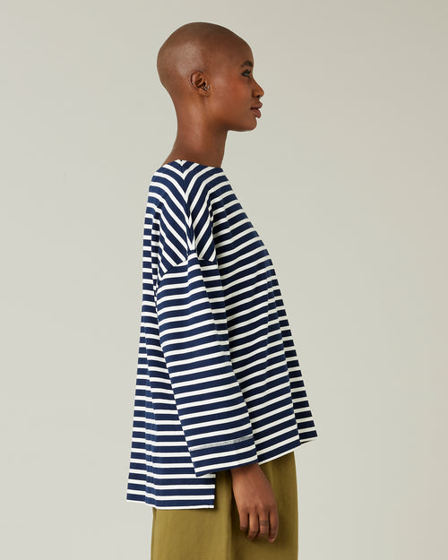 model wears navy and ecru breton top