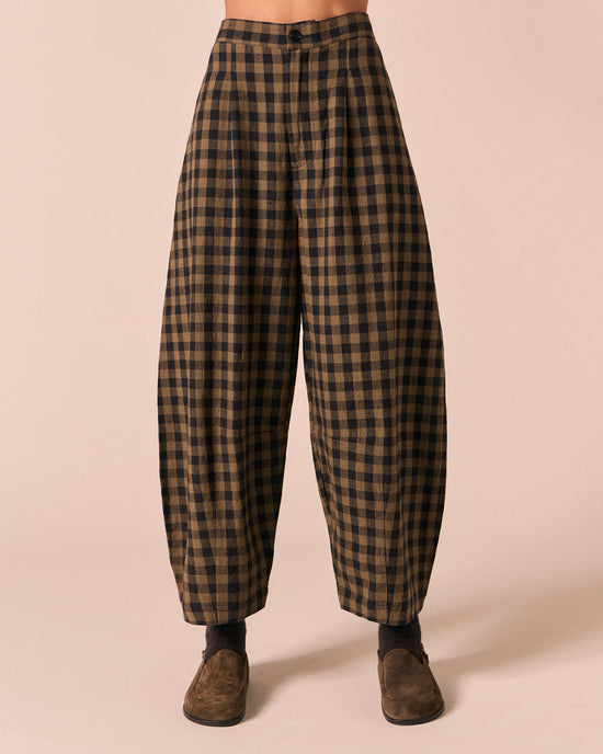 moodel wears dana dark olive gingham linen trousers front