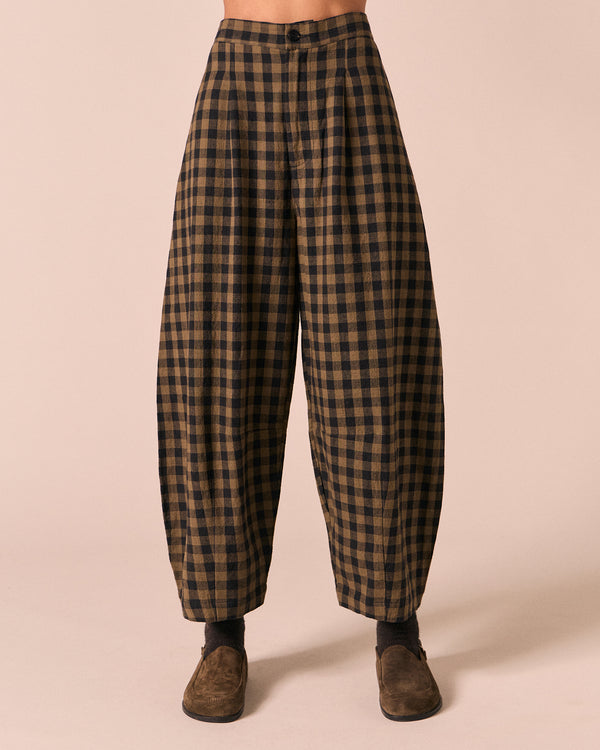 moodel wears dana dark olive gingham linen trousers front