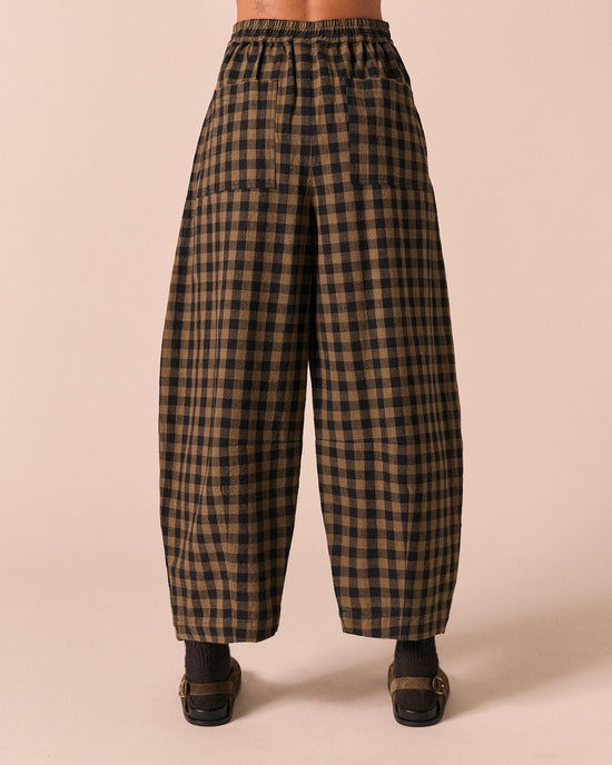 moodel wears dana dark olive gingham linen trousers back
