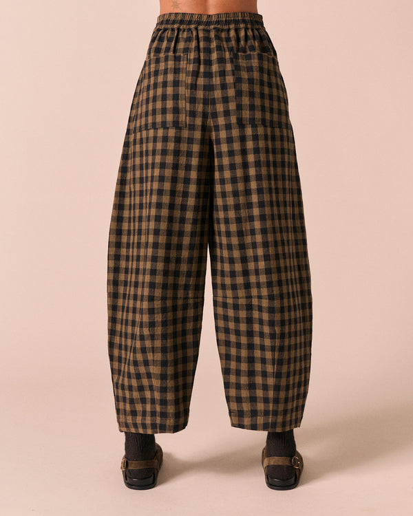 moodel wears dana dark olive gingham linen trousers back