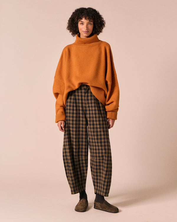 moodel wears dana dark olive gingham linen trousers left