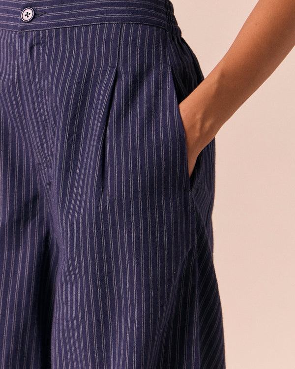 model wears dana midnight pinstripe cotton linen trousers