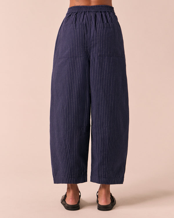 model wears dana midnight pinstripe cotton linen trousers back