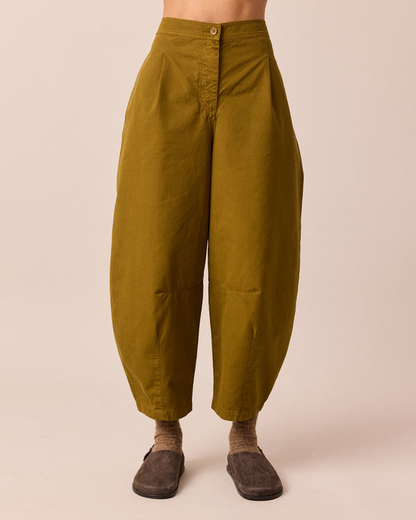 model wears dana golden olive cotton trousers front