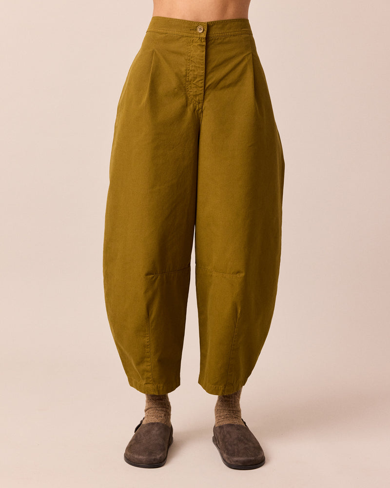 model wears dana golden olive cotton trousers front