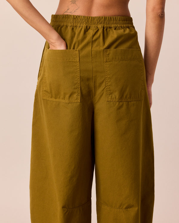 model wears dana golden olive cotton trousers 