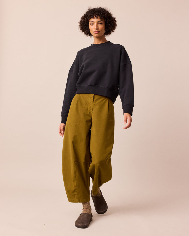 model wears dana golden olive cotton trousers right