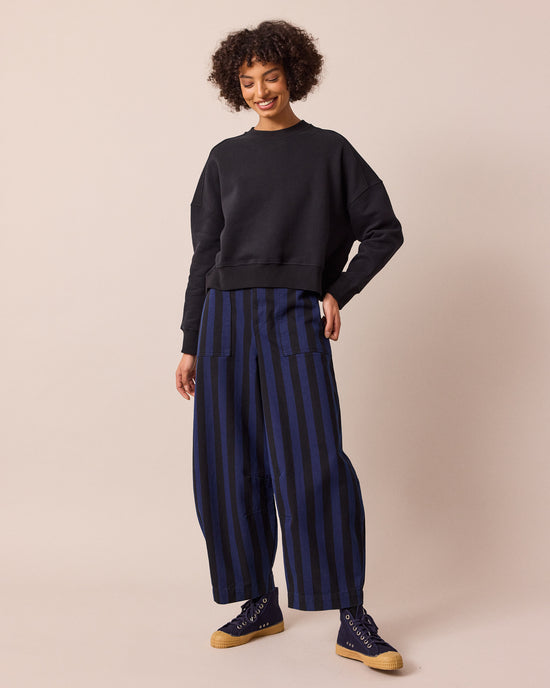 model wears dani blue and black stripe denim jeans left