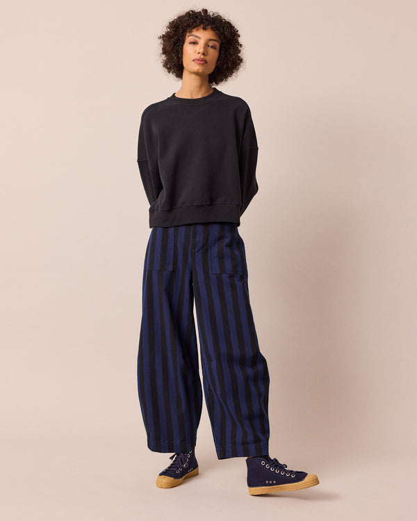 model wears dani blue and black stripe denim jeans right