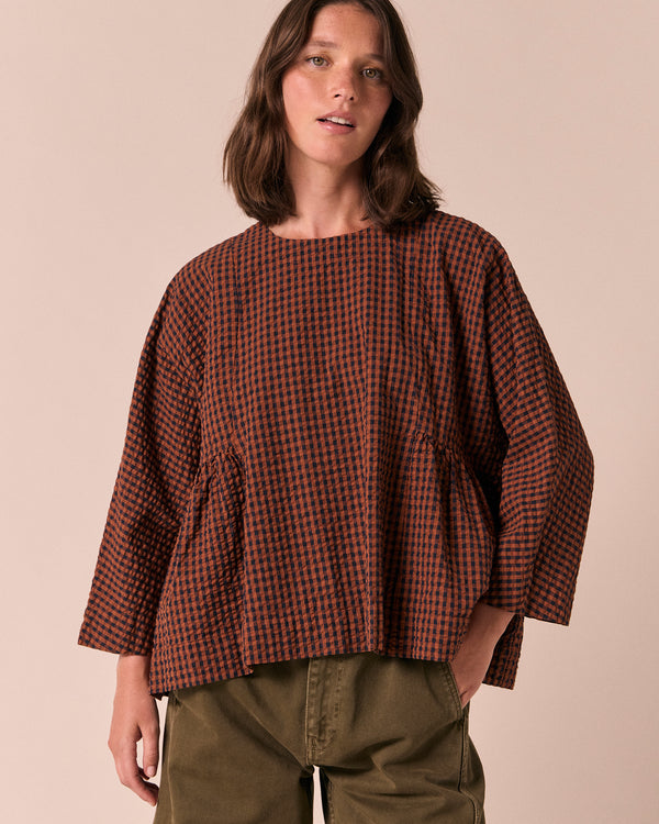 model wears danya russet gingham seersucker top