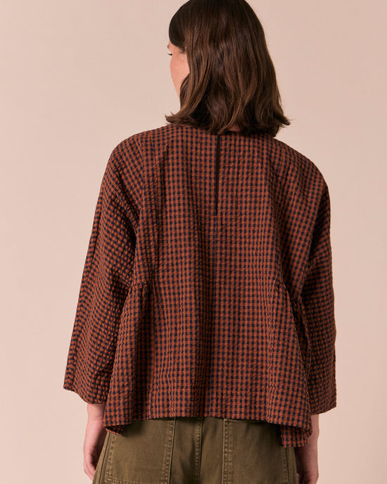 model wears danya russet gingham seersucker top
