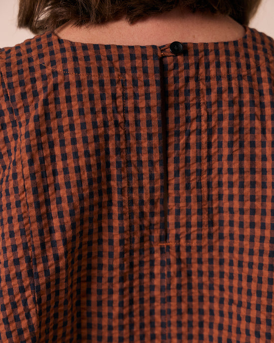 model wears danya russet gingham seersucker top