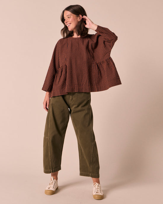 model wears danya russet gingham seersucker top