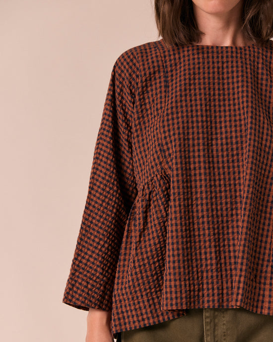 model wears danya russet gingham seersucker top