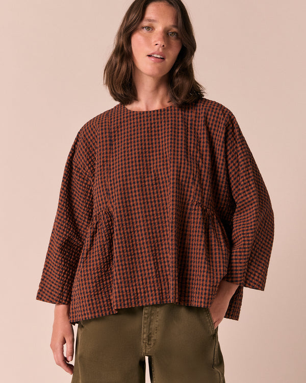 model wears danya russet gingham seersucker top