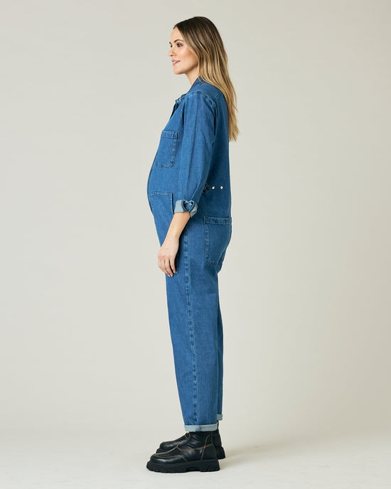 pregnant model wears mid blue denim coverall