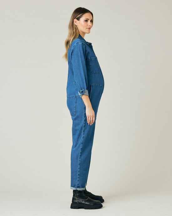 pregnant model wears mid blue denim coverall