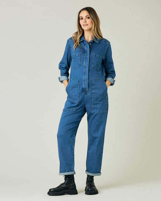 pregnant model wears mid blue denim coverall