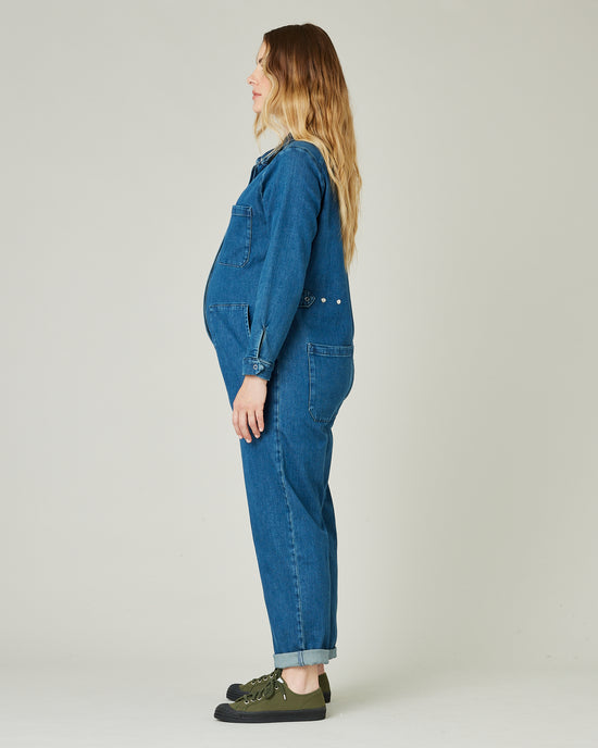 pregnant model wears mid blue denim coverall