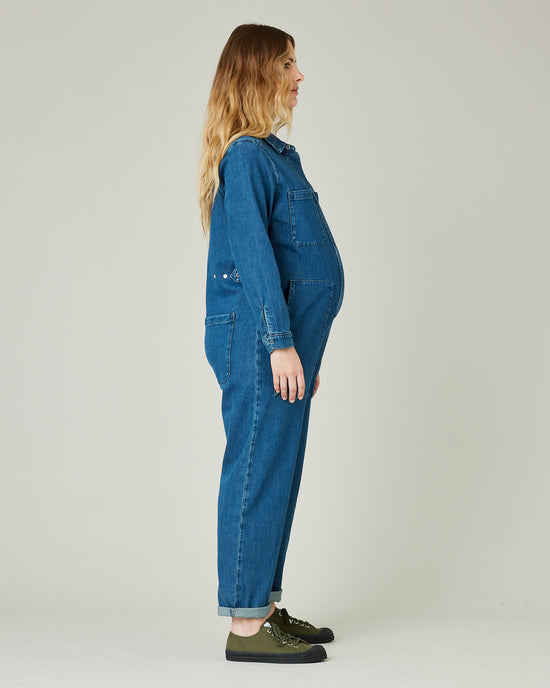 pregnant model wears mid blue denim coverall