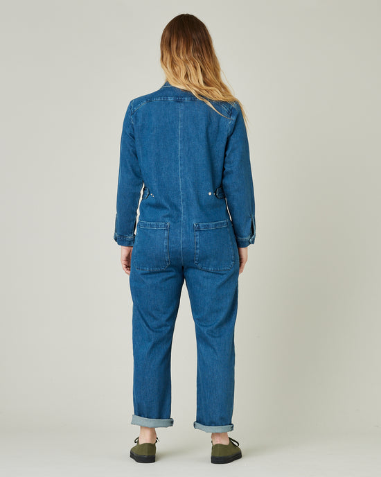 pregnant model wears mid blue denim coverall