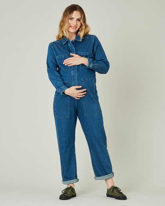 pregnant model wears mid blue denim coverall