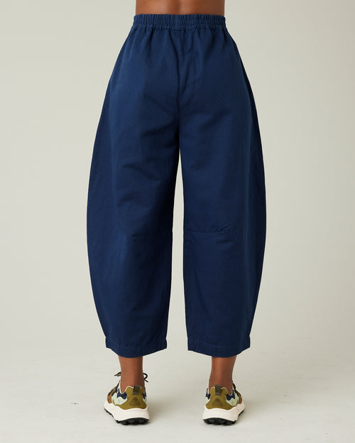 model wears navy daisy twill trousers back