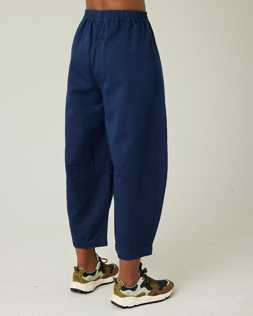 model wears navy daisy twill trousers right