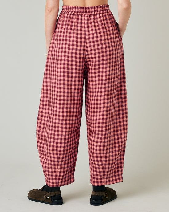 model wears blush gingham linen daisy trousers back