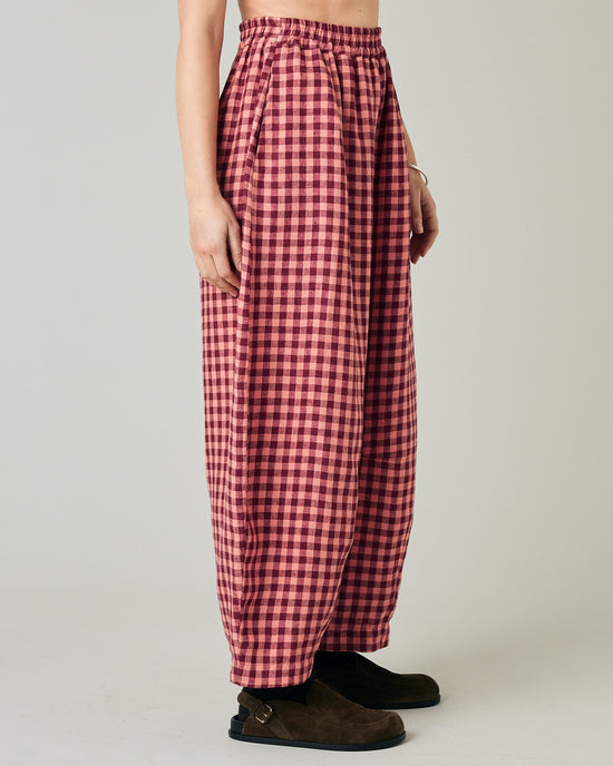 model wears blush gingham linen daisy trousers right