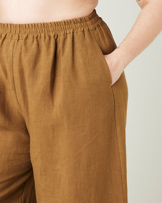 model wears bronze daisy linen trousers