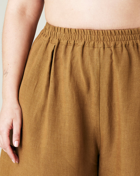 model wears bronze daisy linen trousers