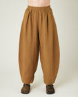 model wears bronze daisy linen trousers front