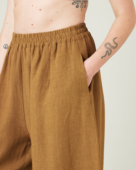 model wears bronze daisy linen trousers