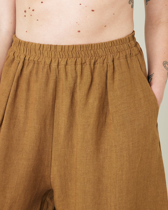 model wears bronze daisy linen trousers