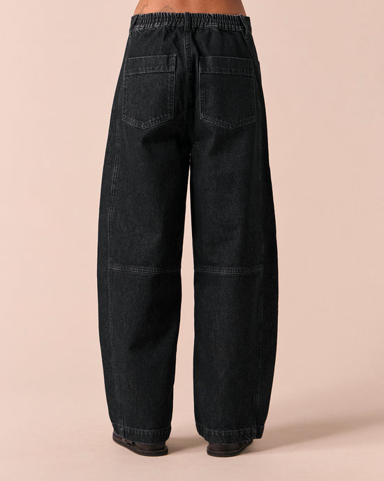 model wears echo washed black denim jeans back