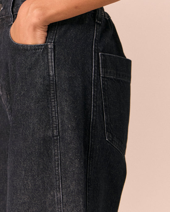 model wears echo steel blue denim jeans