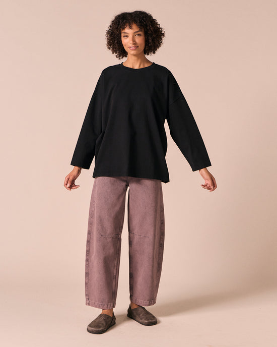 model wears echo smoked lilac denim jeans left