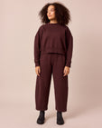 model wears eden black cherry jersey jumper and lyra black cherry jersey trousers