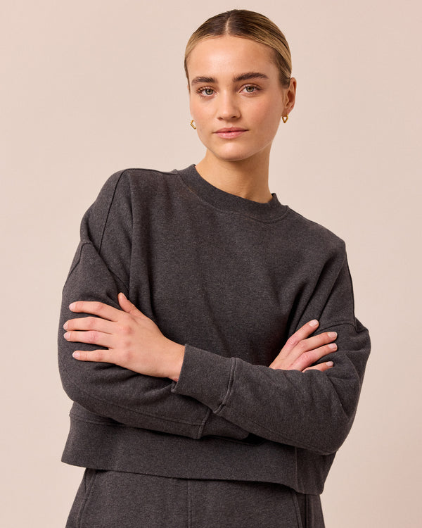 model wears eden charcoal marl fleeceback jersey jumper