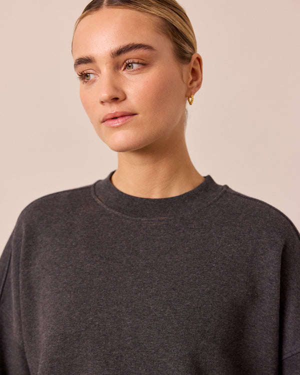 model wears eden charcoal marl fleeceback jersey jumper