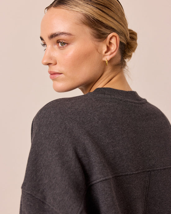 model wears eden charcoal marl fleeceback jersey jumper